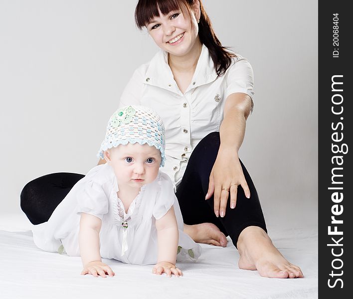 Mother and little daughter sits on the floor. Mother and little daughter sits on the floor