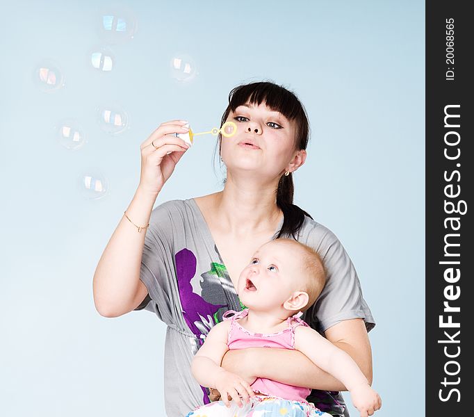 Mother And Daughter Blowing Bubbles