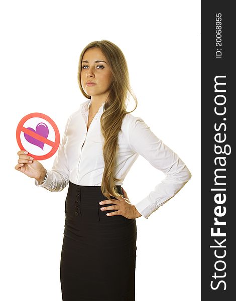 Close-up of an attractive young business woman holding a sign with a crossed ban heart. Isolation. Close-up of an attractive young business woman holding a sign with a crossed ban heart. Isolation