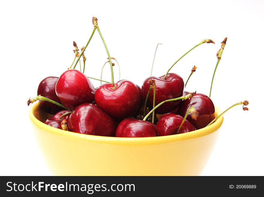 Dish of cherries isolated on white background