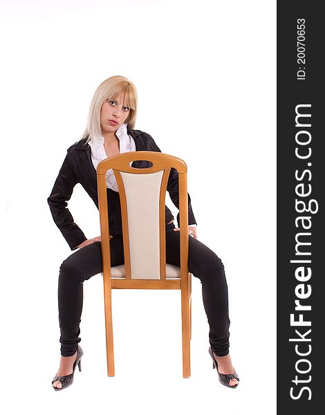 Girl sitting on wooden chair isolated over white
