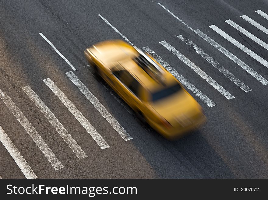 Yellow taxi of New York traversing a zebra crossing. Yellow taxi of New York traversing a zebra crossing
