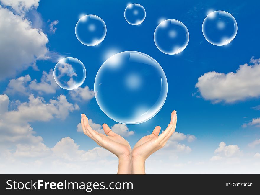 Hand hold Bubbles in the blue sky. Hand hold Bubbles in the blue sky