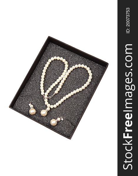 Pearl necklace and ear-rings over white background. Pearl necklace and ear-rings over white background.