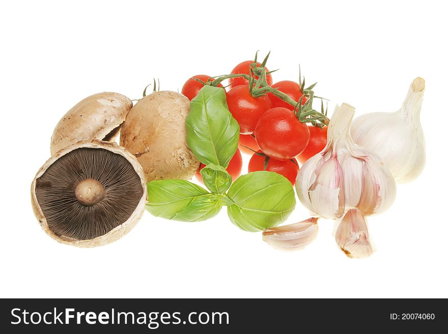 Complimentary food ingredients of mushrooms,basil,tomatoes and garlic isolated on white