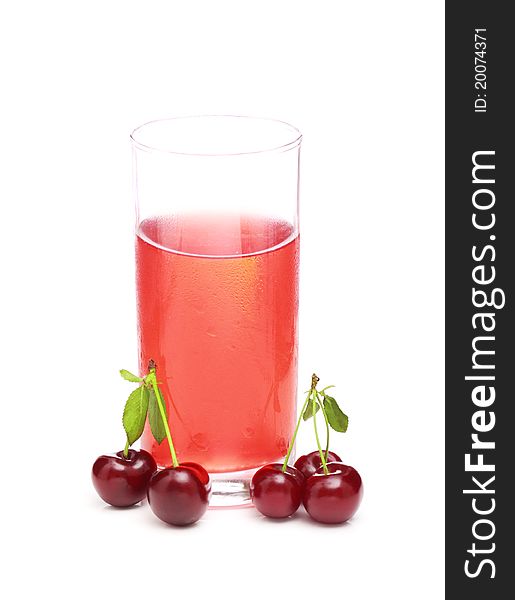 A glass of juice and a cherries on a white background