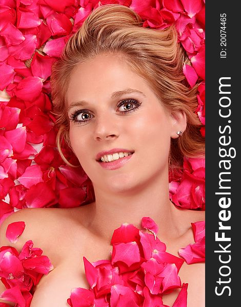 Attractive blond girl portrait in roses petals. Attractive blond girl portrait in roses petals.