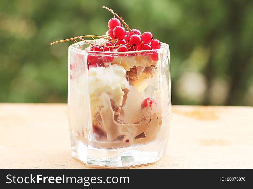 Ice cream in a glass with red currants. Ice cream in a glass with red currants