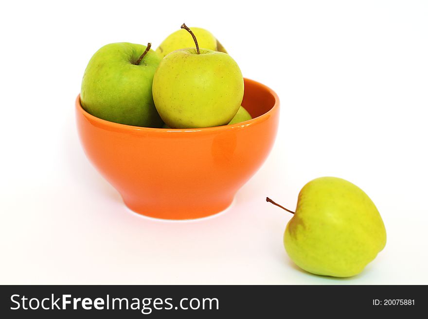 Green apples in the orange Bowl