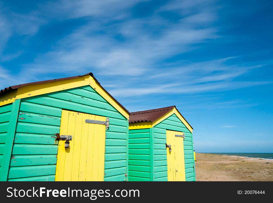 Green and yellow  beach huts in summer