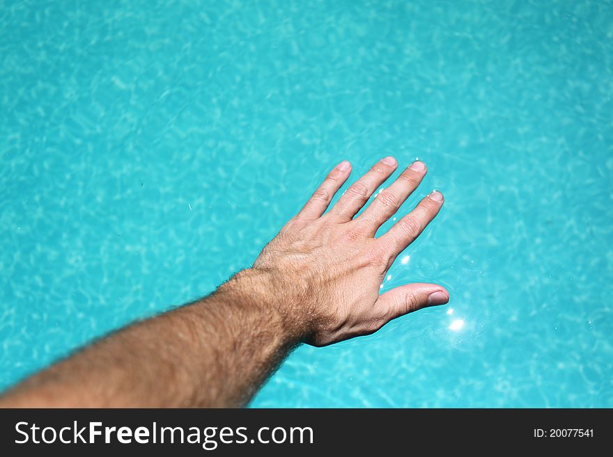 Hand floating on pool water. Hand floating on pool water