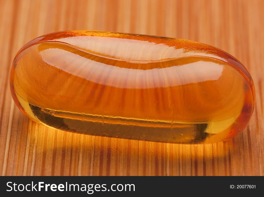 Medical pill against diseases on a wooden table.