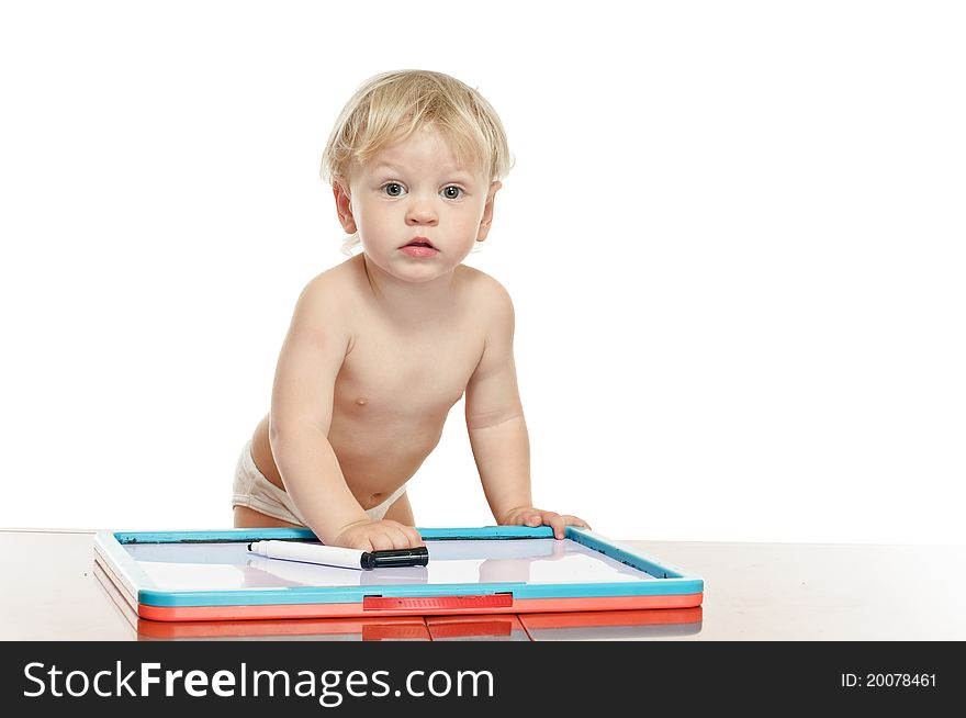 Two years old boy with draw desk on the table. Two years old boy with draw desk on the table