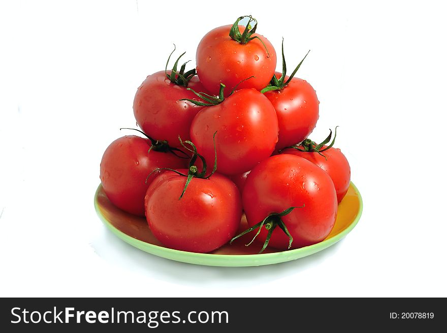 The fresh tomatoes isolated on a plate. The fresh tomatoes isolated on a plate