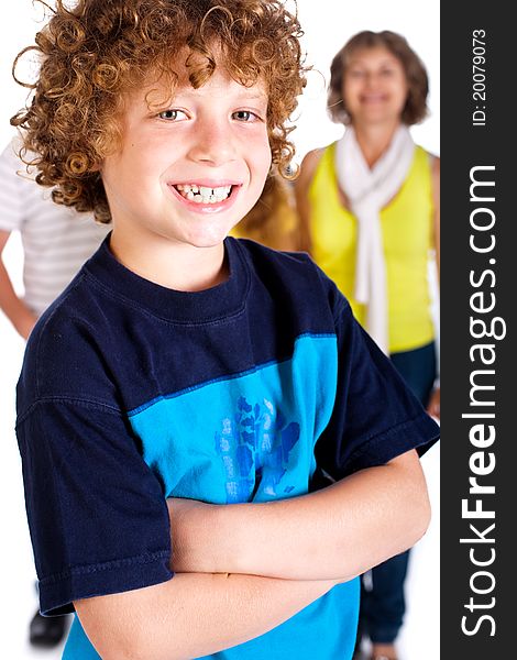 Young cute boy in focus with family in the background, isolated over white.