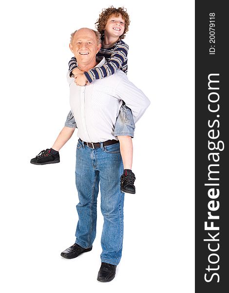 Grandfather giving grandson piggy-back against white background.