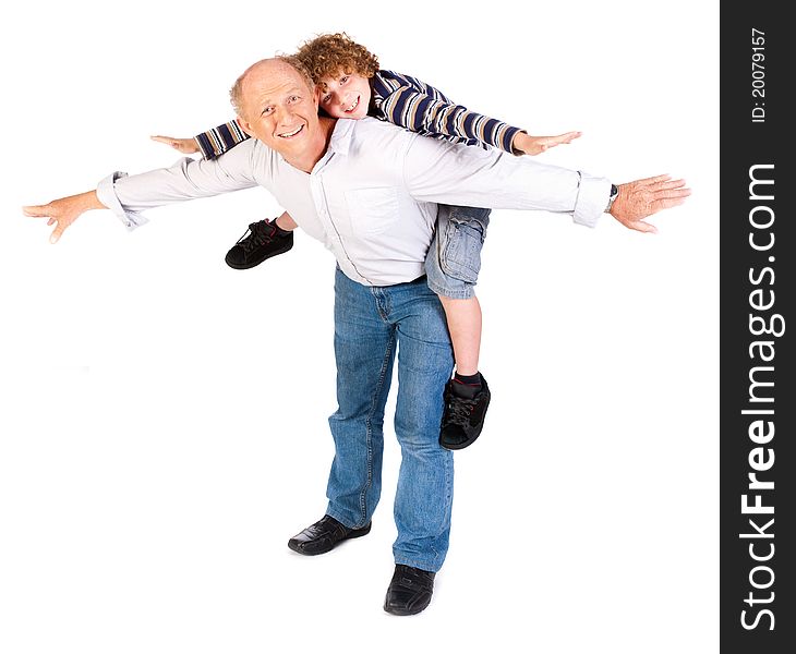 Grandfather giving grandson piggy-back against white background.