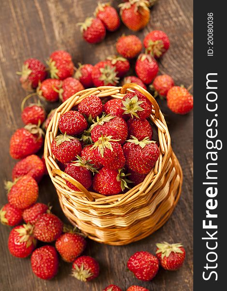 Strawberries in a basket and cheese, are a number of chamomile flowers, environmentally friendly product