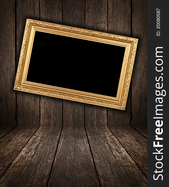 Rusty vintage wooden interior with golden frame hanging on the wall