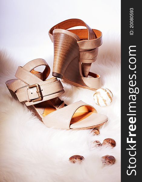 Fashionable elegant sandals on the fur background
