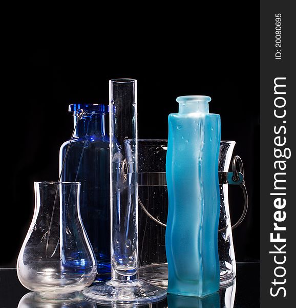 Group of beautiful handmade vases on a black background with illumination from behind