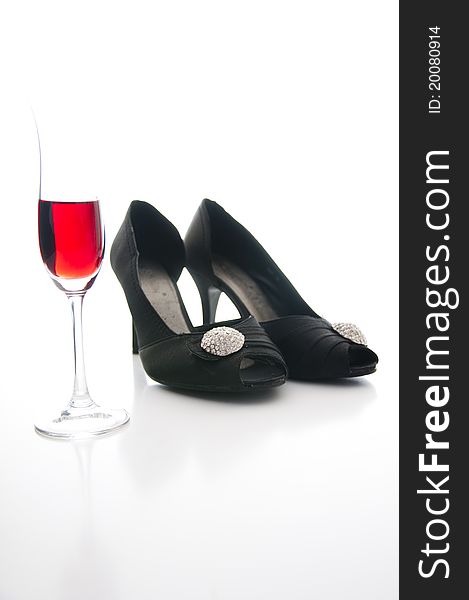 Red wine and black shoes on white background. Red wine and black shoes on white background