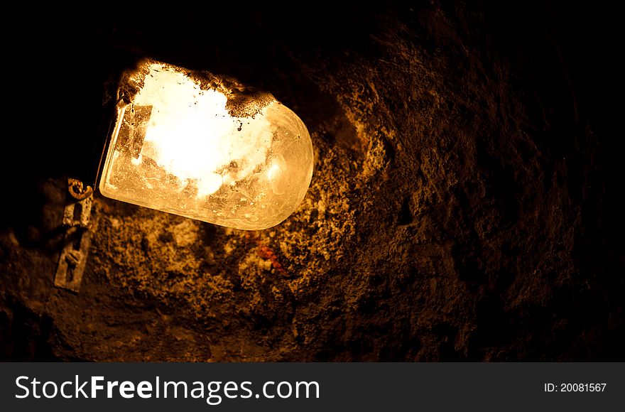 Old electric light in cavern in the dark