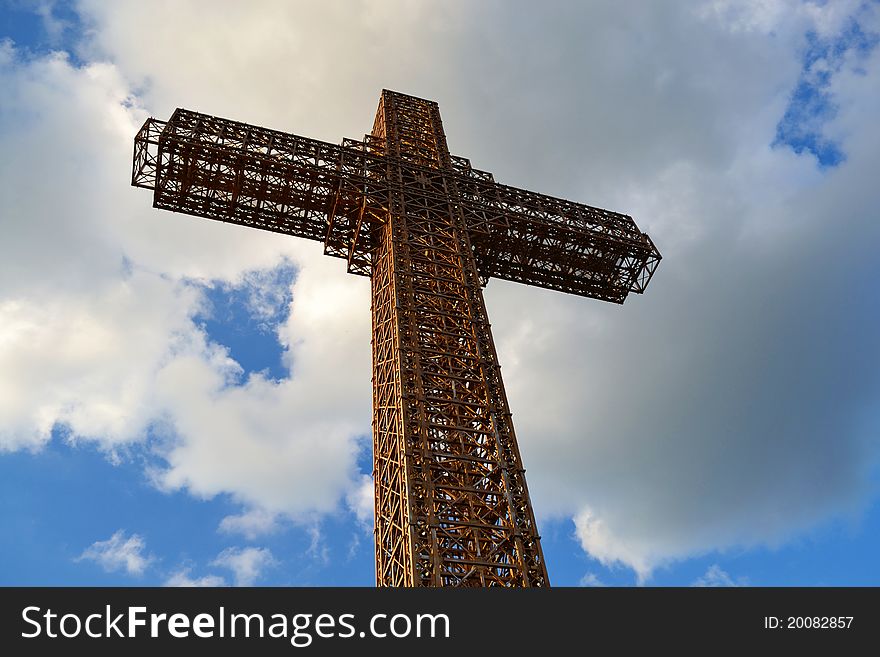 Large metal cross with clouds