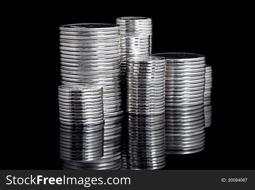 Silver coin stack on black background