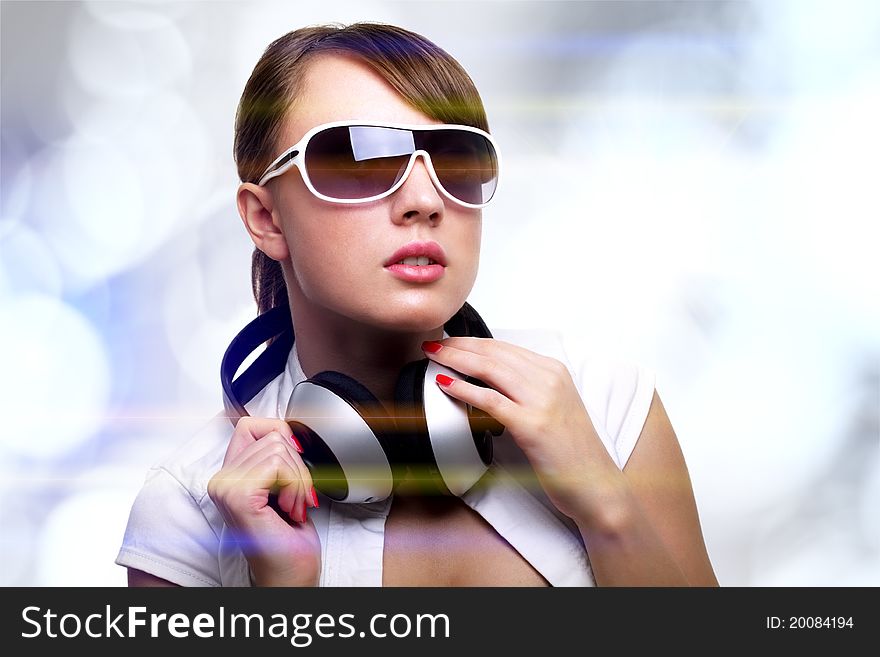 Girl with headphones on bright background