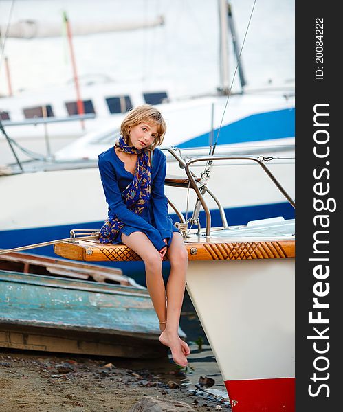 Playful pretty little girl on sail boat