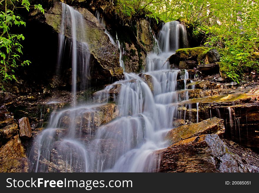 This image of the stream fed by snow melt and flowing down a series of rocky steps was taken at a very slow shutter speed in NW Montana. This image of the stream fed by snow melt and flowing down a series of rocky steps was taken at a very slow shutter speed in NW Montana.