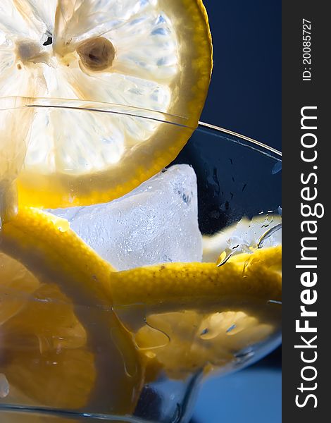 Close up of lemon wedge in glass of ice water. Close up of lemon wedge in glass of ice water
