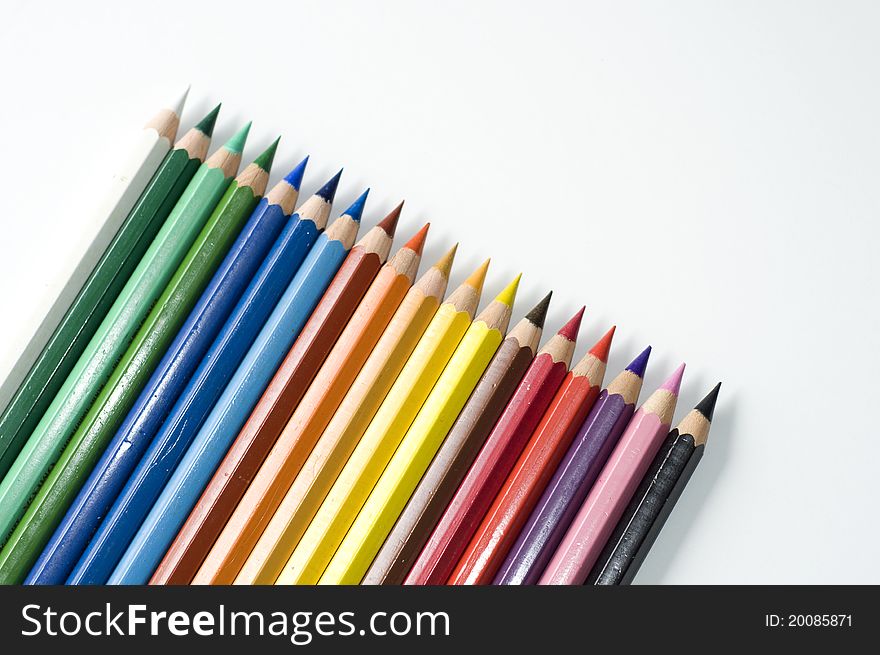 Colored pencils on white background. Sharpened rods. Colorful.