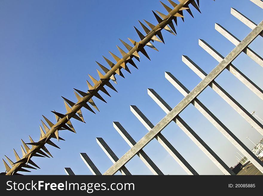 Barbed wire fence at the blue sky. metaphor of freedom and incarceration