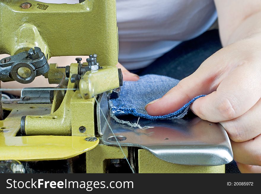 The picture shows a seamstress at work. The picture shows a seamstress at work