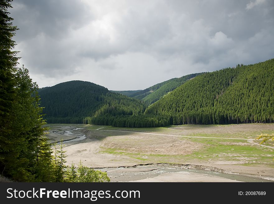 River flowing through a mountain valley in a cloud