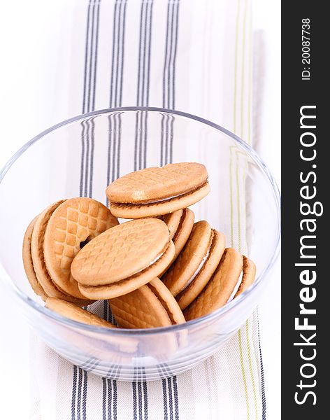 Cookies in a glass dish on white background