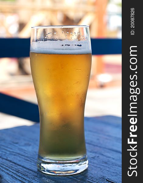Glass of beer on a blue wooden table