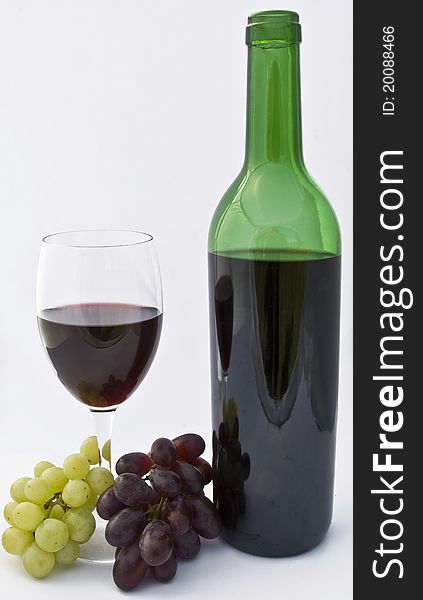 Glass Of Wine And Bottle With Grapes