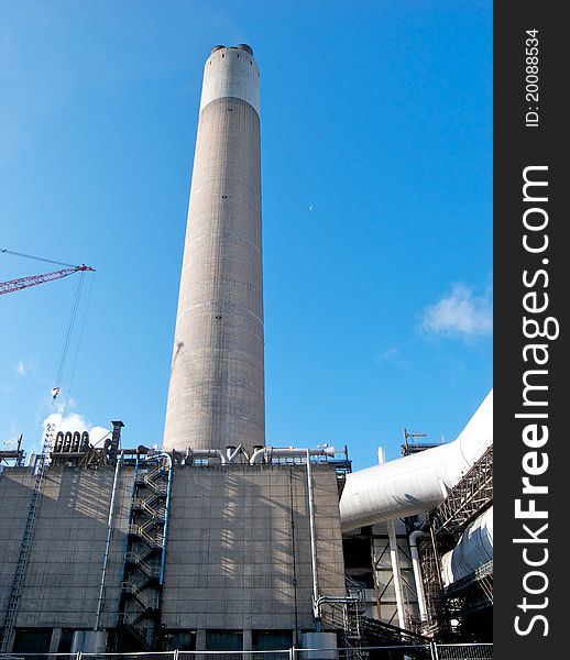 Coal fired power station chimney in the early morning sunlight