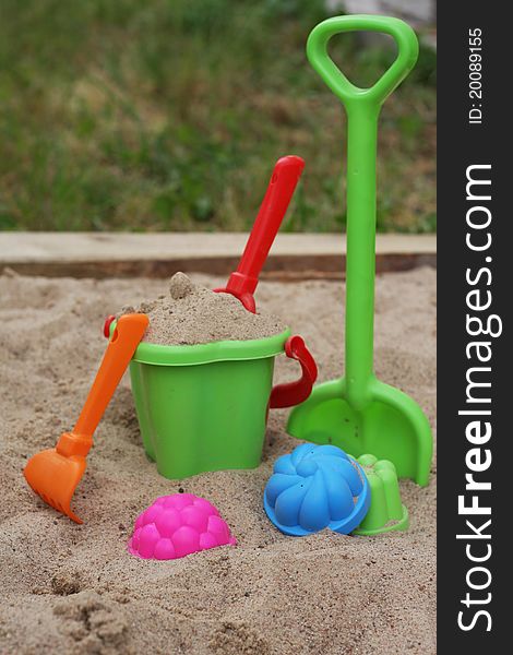 Sandbox with a multi-colored set of children's toys. Sandbox with a multi-colored set of children's toys