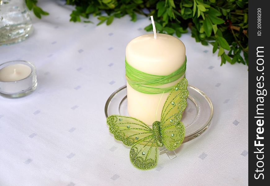 A candle and a butterfly on white background. A candle and a butterfly on white background.