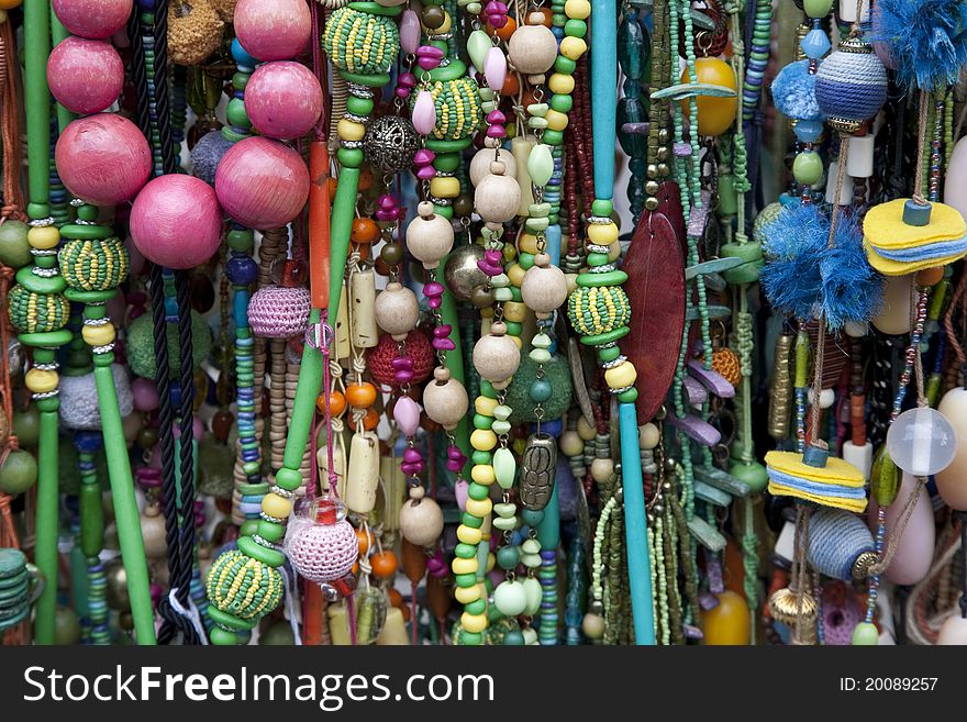 Multi-colored necklaces and other complements on sale on market stall. Multi-colored necklaces and other complements on sale on market stall