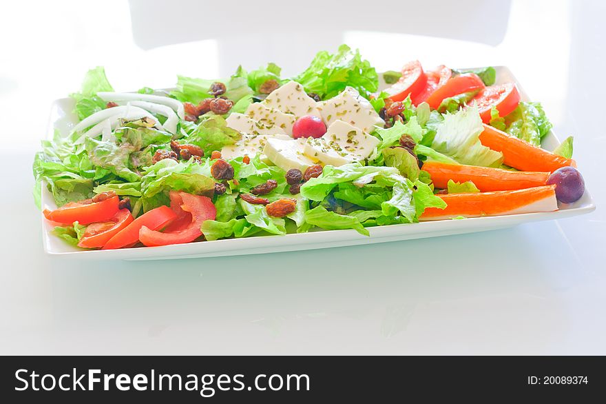Fresh salad in a plate with white background. Fresh salad in a plate with white background