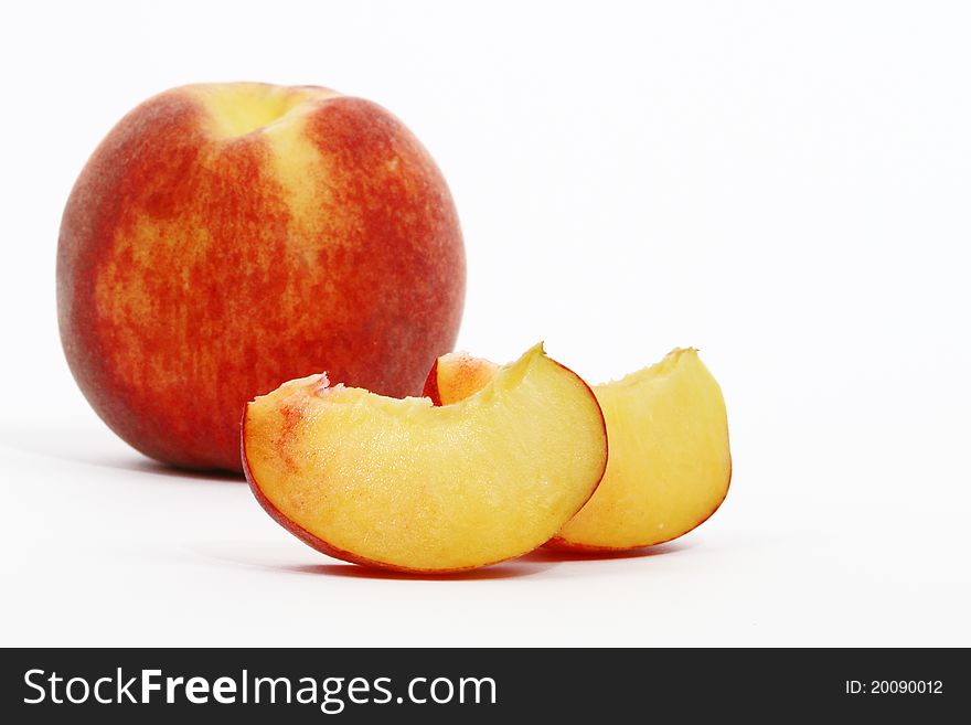 Peaches cut into wedges and whole peach