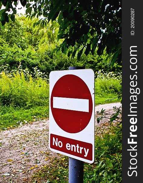 A no entry sign at the start of a dirt track