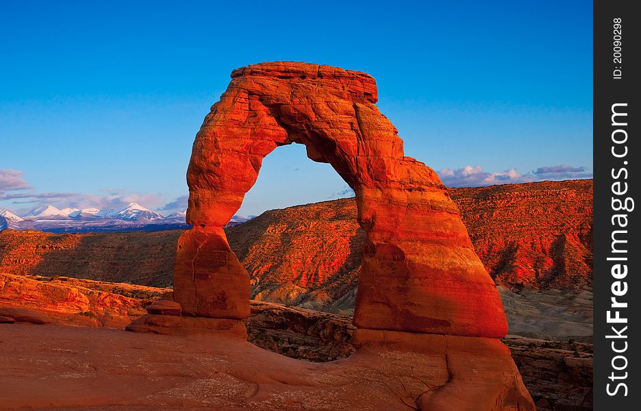 The famous Delicate Arch in Arches National Park, Utah glowing under the setting sun.