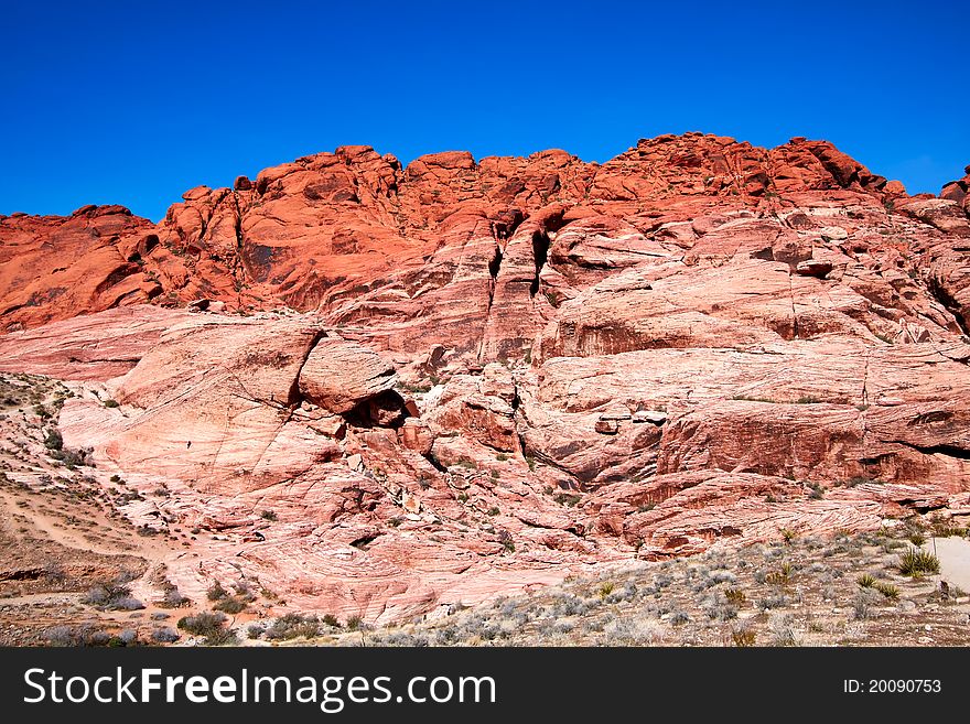 View of dry landscape and red rock formations of the Mojave Desert. View of dry landscape and red rock formations of the Mojave Desert..