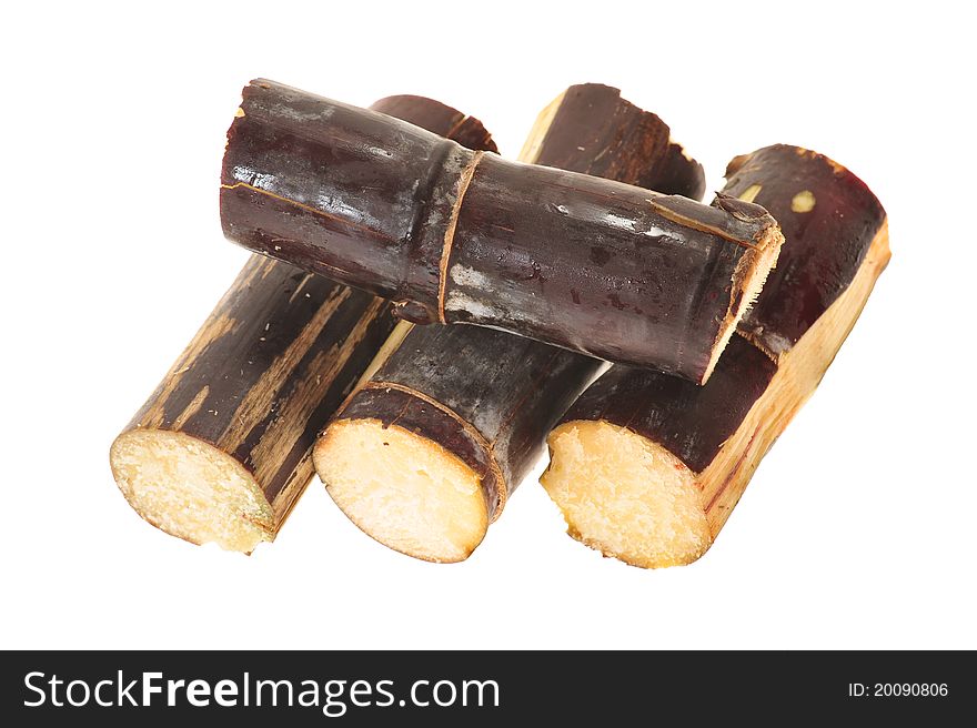 Short Stumps Of Maroon Colored Sugarcane Arranged On A White Background